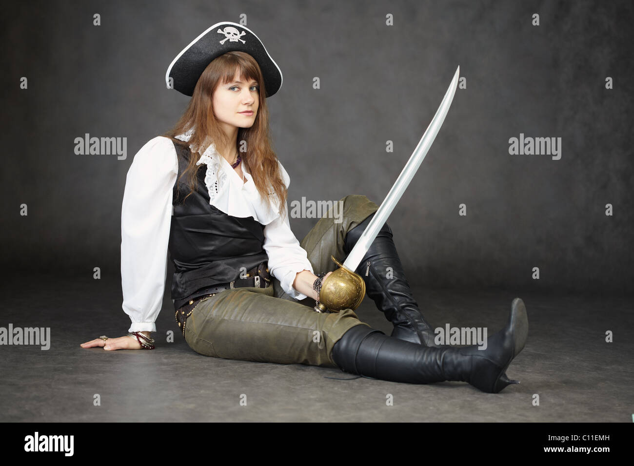 Young beautiful woman in clothes of pirate with sabre Stock Photo