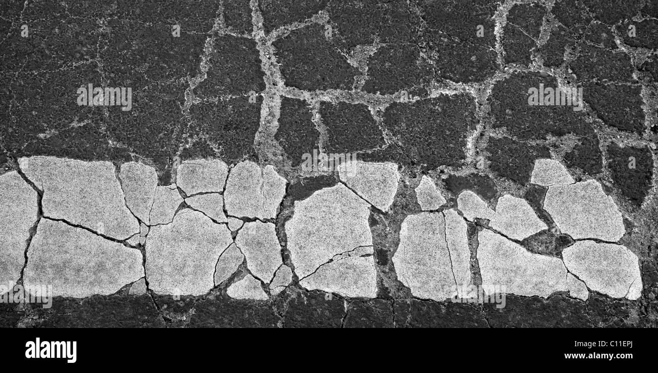 Asphalt cracked by frost in the winter in the city Stock Photo