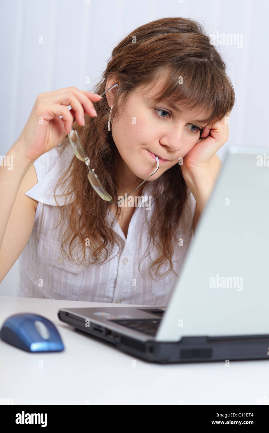 Young beautiful woman with concentration studies laptop Stock Photo
