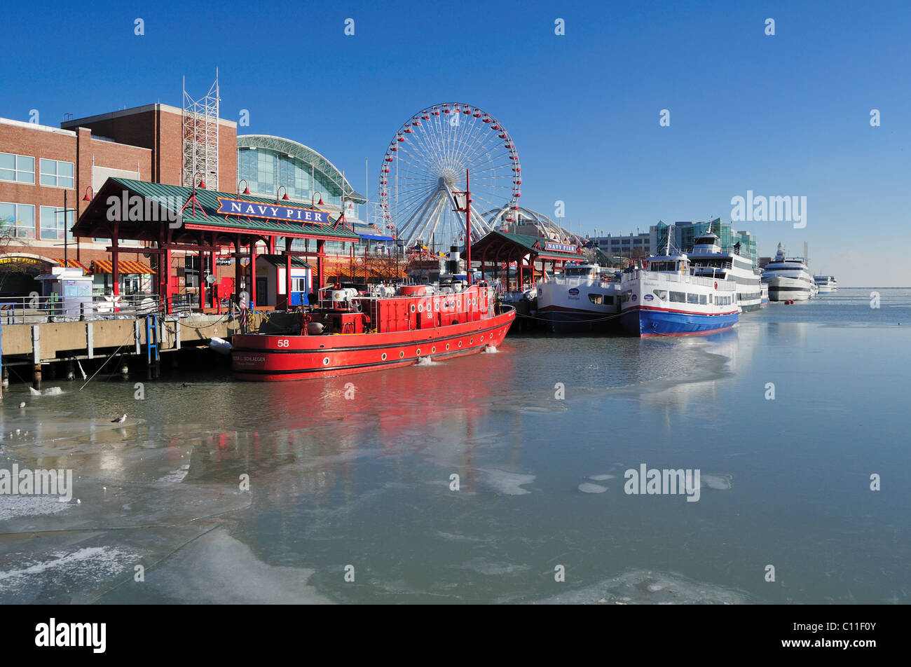 Ice begins forming in the harbor near Navy Pier and the ships tied up at its moorings on a cold December day. Chicago Illinois, USA. Stock Photo