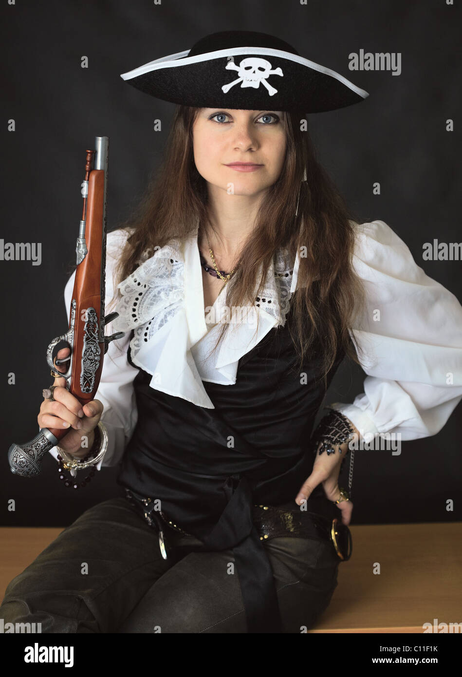 Young beautiful girl - sea pirate with pistol Stock Photo