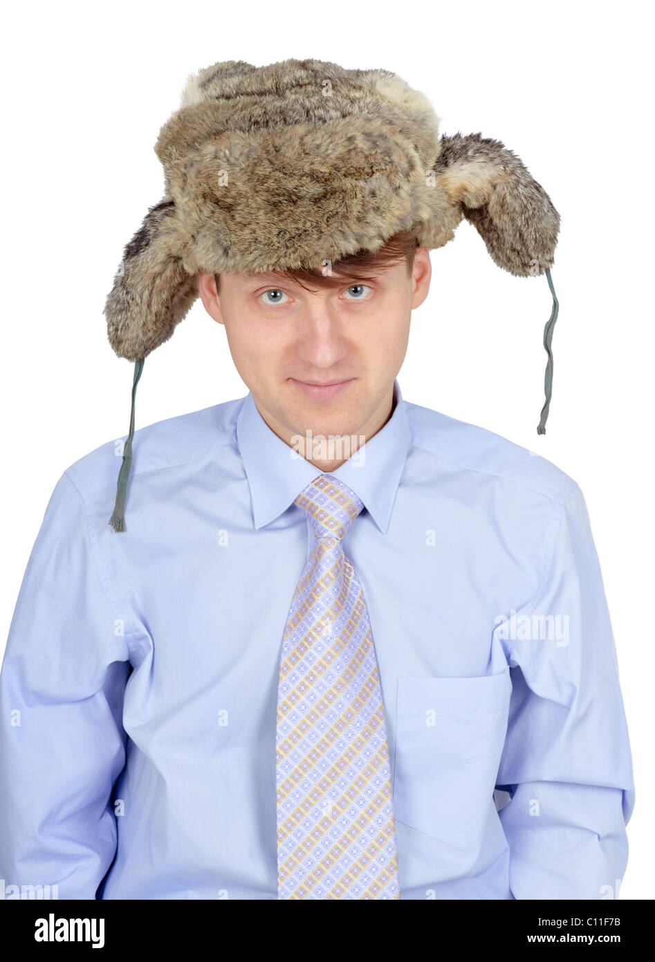 Portrait of young man in fur hat isolated on white background Stock Photo