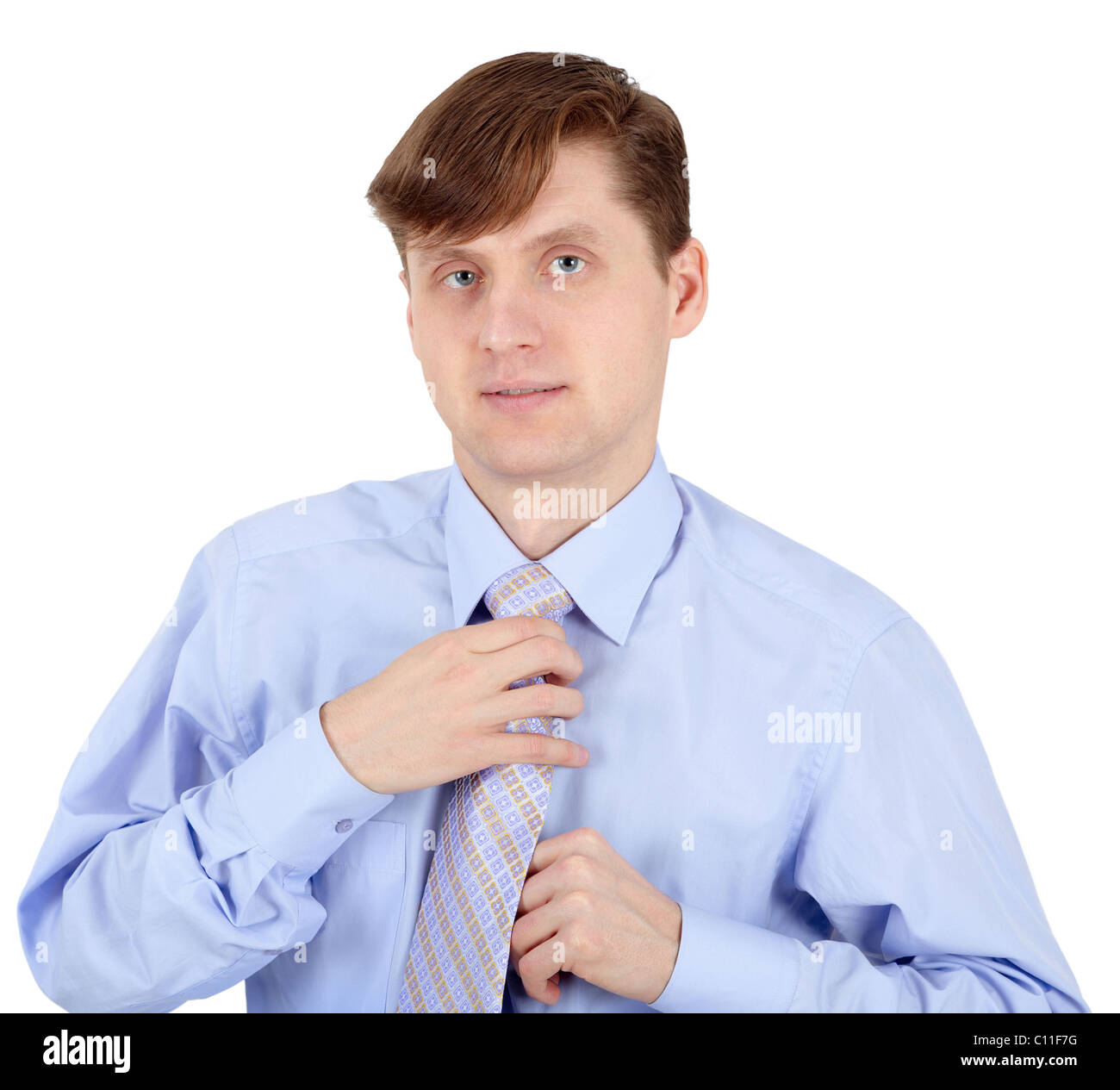 Young man adjusts his tie Stock Photo