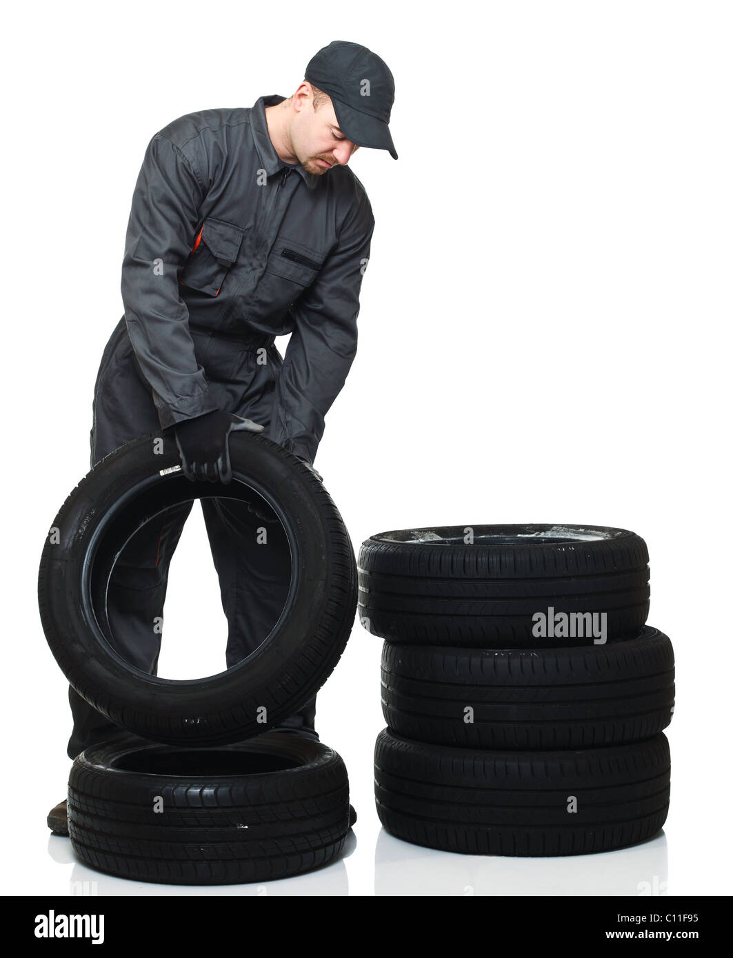 caucasian tire repairer on duty isolated on white background Stock Photo