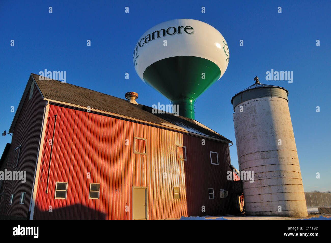 A red barn and silo by a water tower Sycamore Illinois, USA. Stock Photo