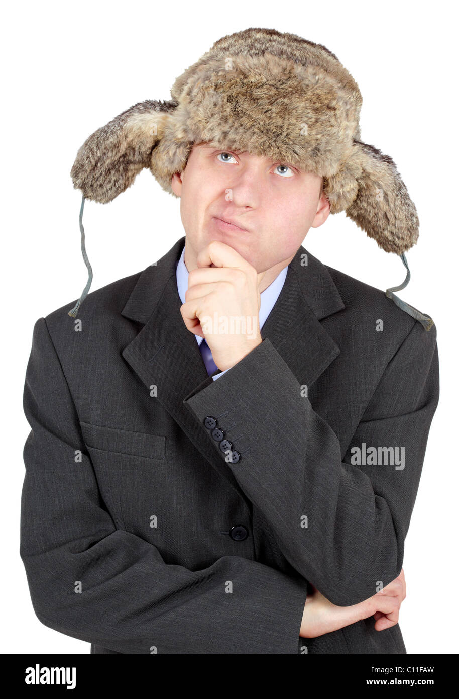 Young man in a fur hat dreams on white background Stock Photo