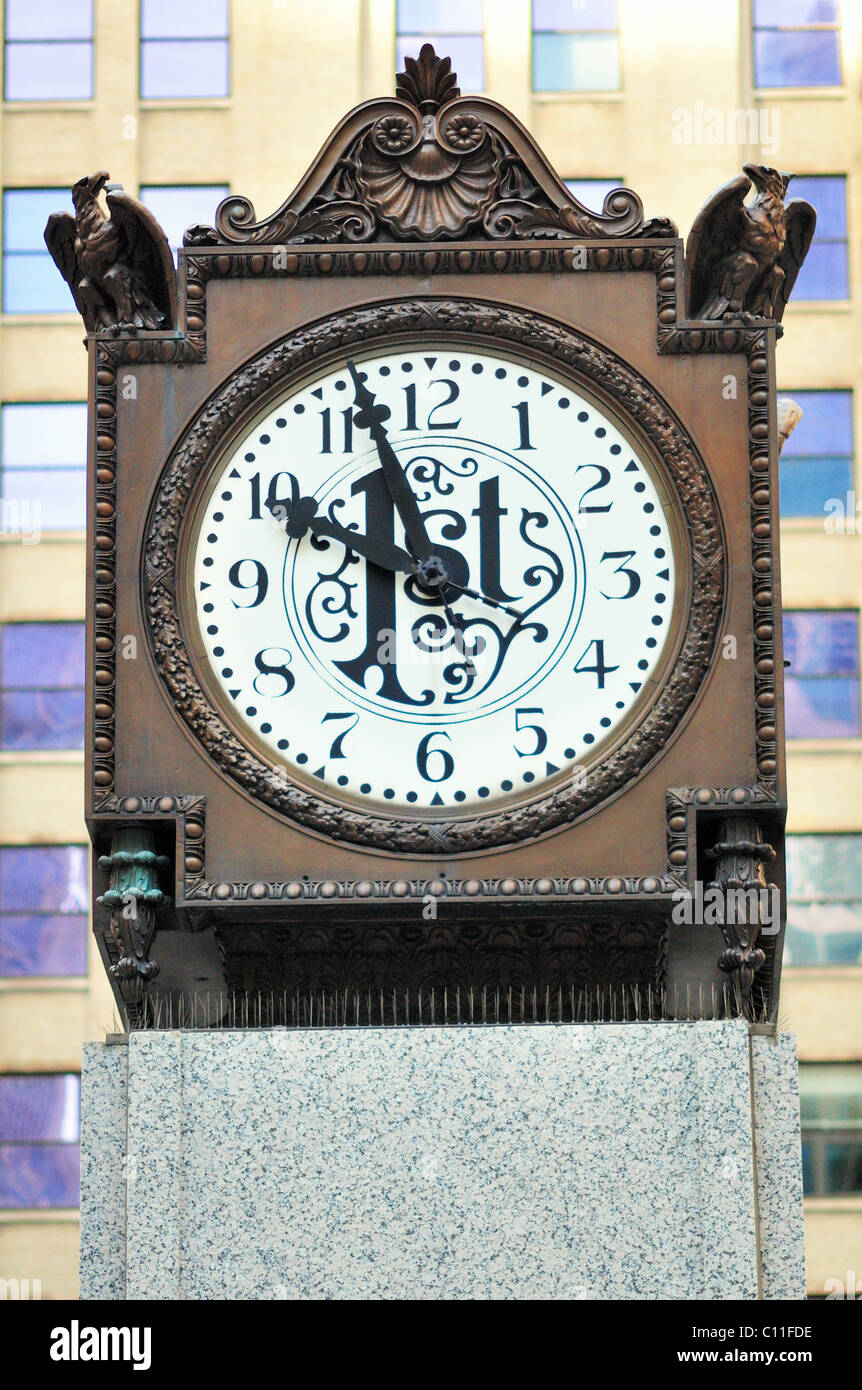 A historic multi-sided clock landmark relocated to pedestal location in the Chase Bank Plaza Chicago, Illinois, USA. Stock Photo