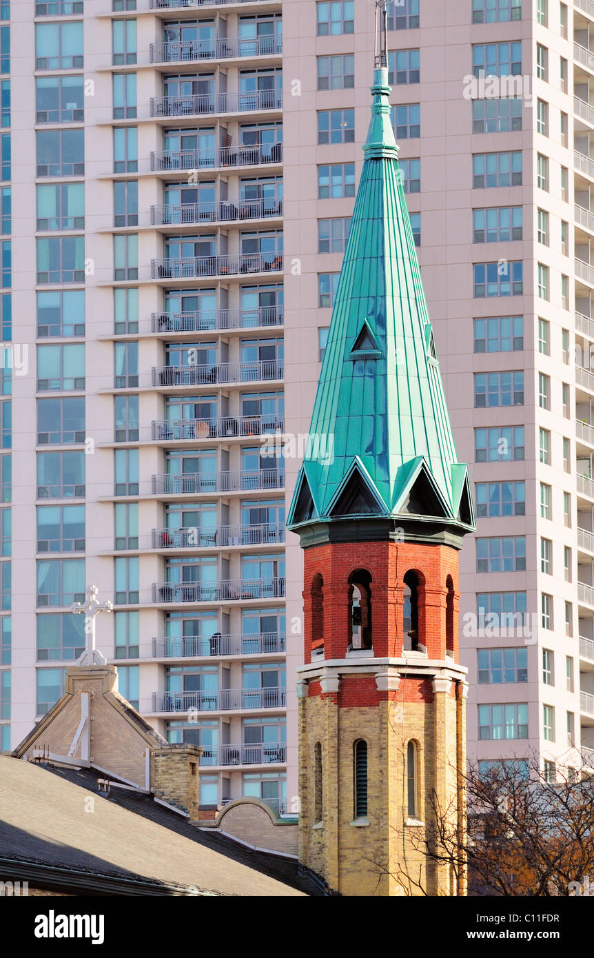 The steeple (spire) of St. Patrick's Catholic Church reflects the late autumn sun. built in 1852, is the oldest in Chicago Illinois, USA. Stock Photo