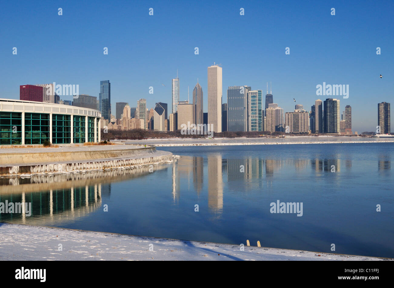 Ice forming in the lakefront harbors of Lake Michigan reflect the city skyline on a very cold December morning Chicago Illinois Stock Photo