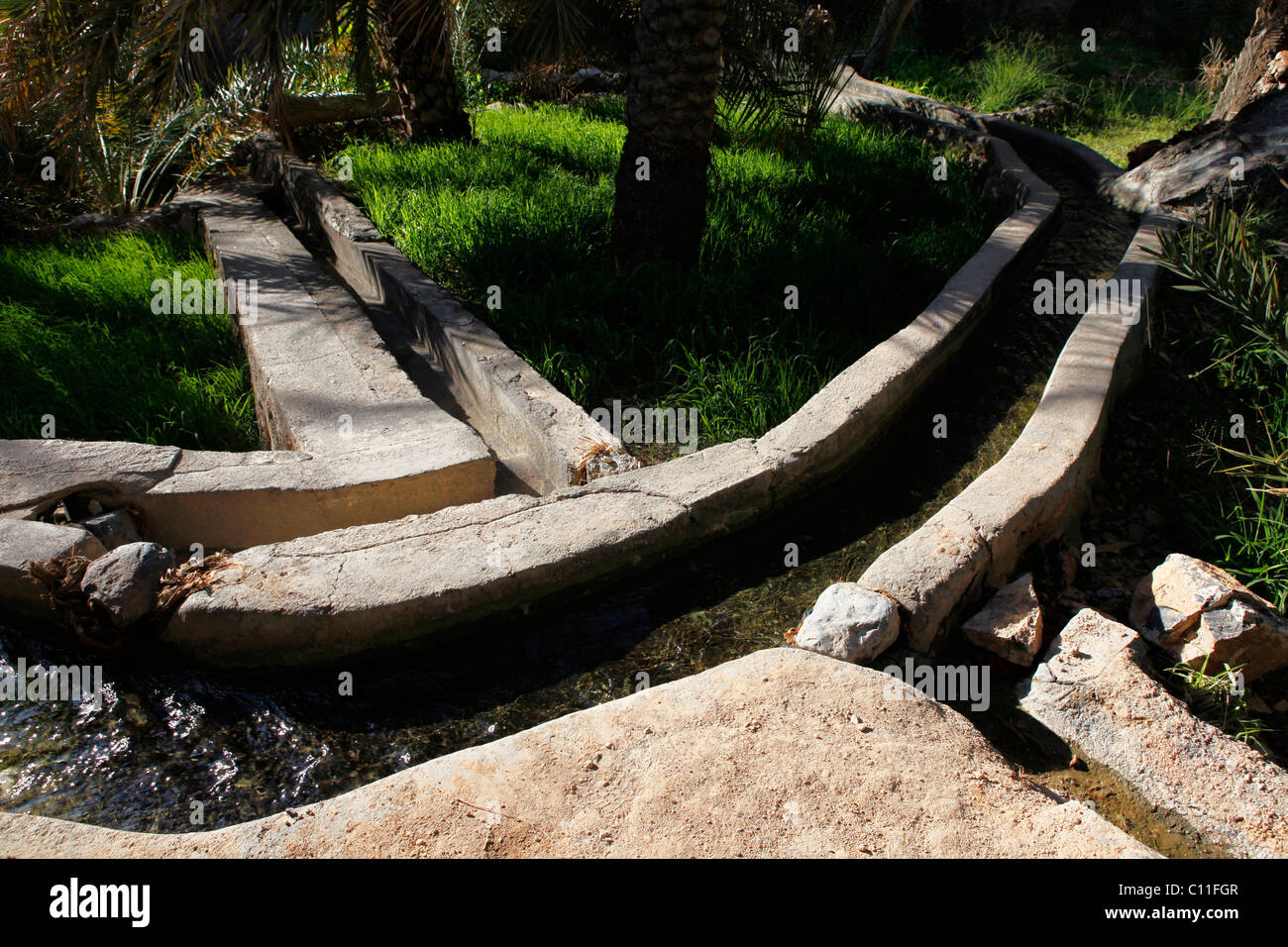 An irrigation channel, known as a Falaj, in the Omani mountain village of Al Hamra. Stock Photo