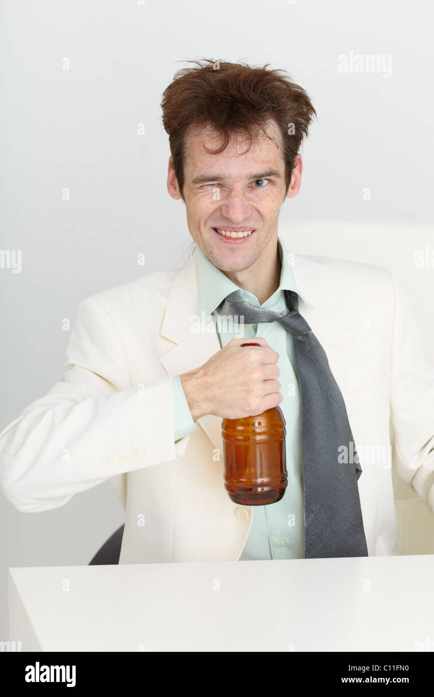 Cheerful guy in a white jacket with bottle of beer Stock Photo Alamy