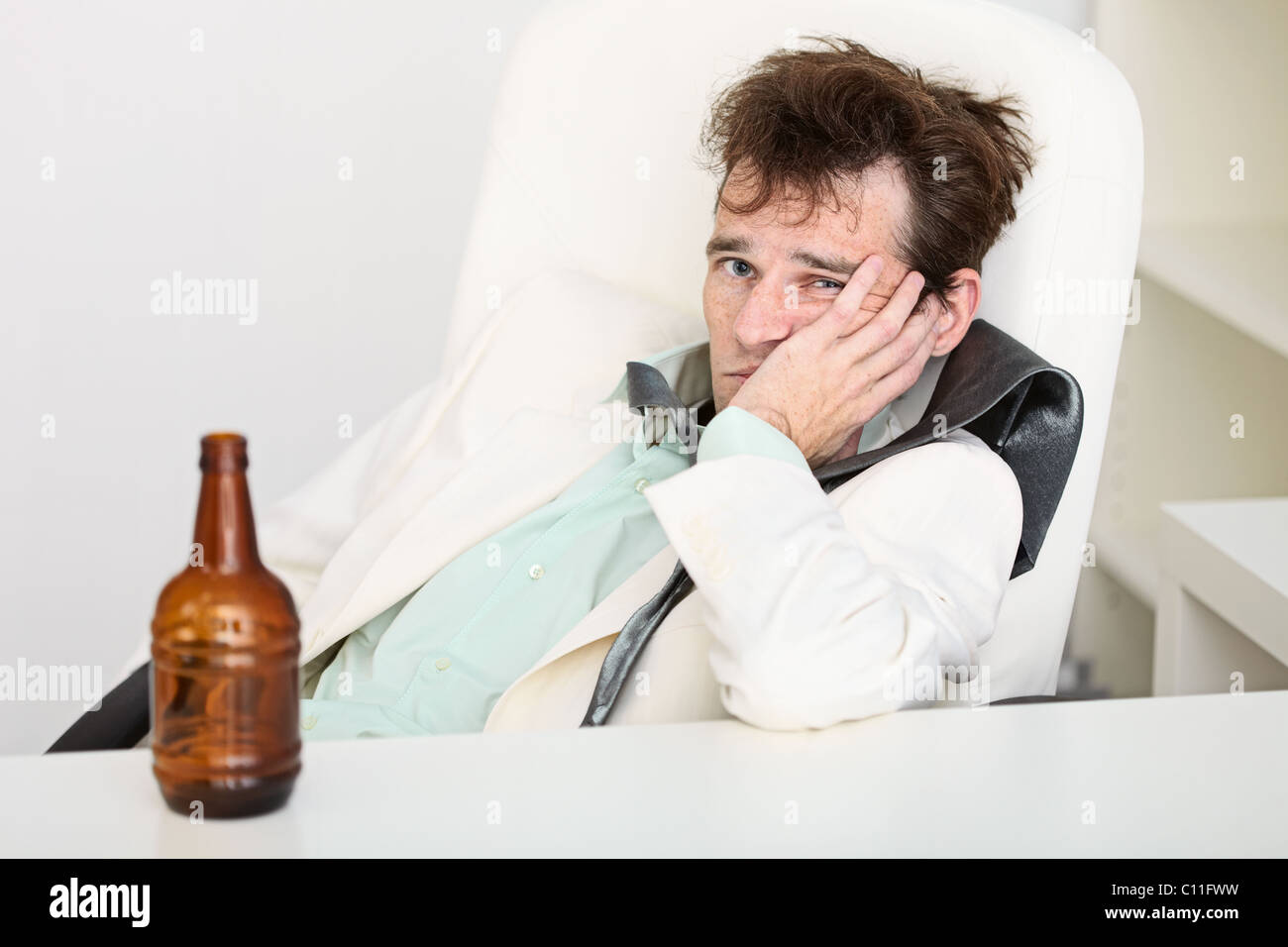 Guy is suffering from hangover because beer is gone Stock Photo