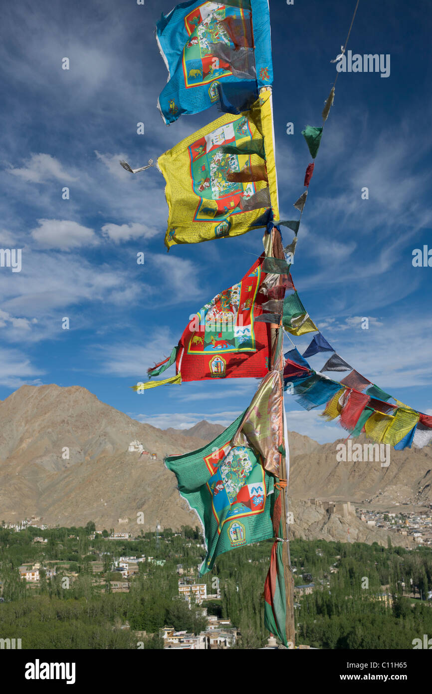 Prayer flags on the Shanti Stupa, with the town of Leh behind, Leh, (Ladakh) Jammu & Kashmir, India Stock Photo