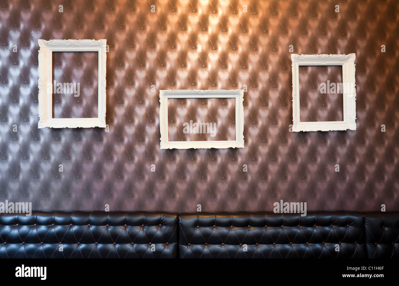 Three empty picture frames on the wall with wallpaper Stock Photo - Alamy