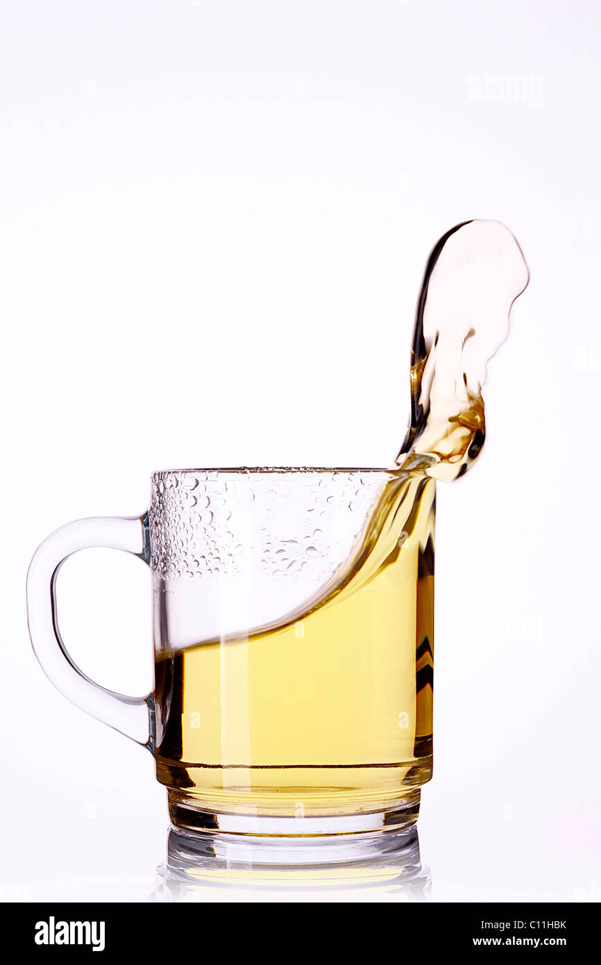 Glass of tea with sloshing tea Stock Photo