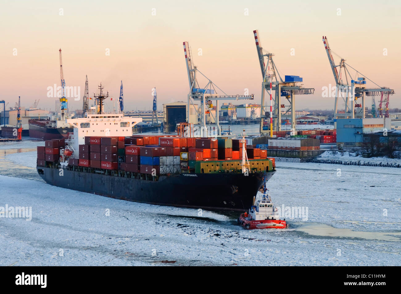 Container ship on the Elbe river in the wintery port of Hamburg, Germany, Europe Stock Photo
