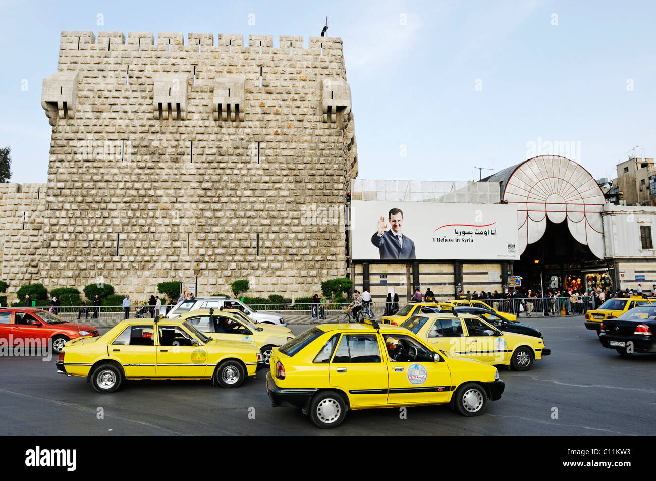Taxis in front of the Citadel of Damascus, entrance to the bazaar, souk on the right, historic centre of Damascus Stock Photo