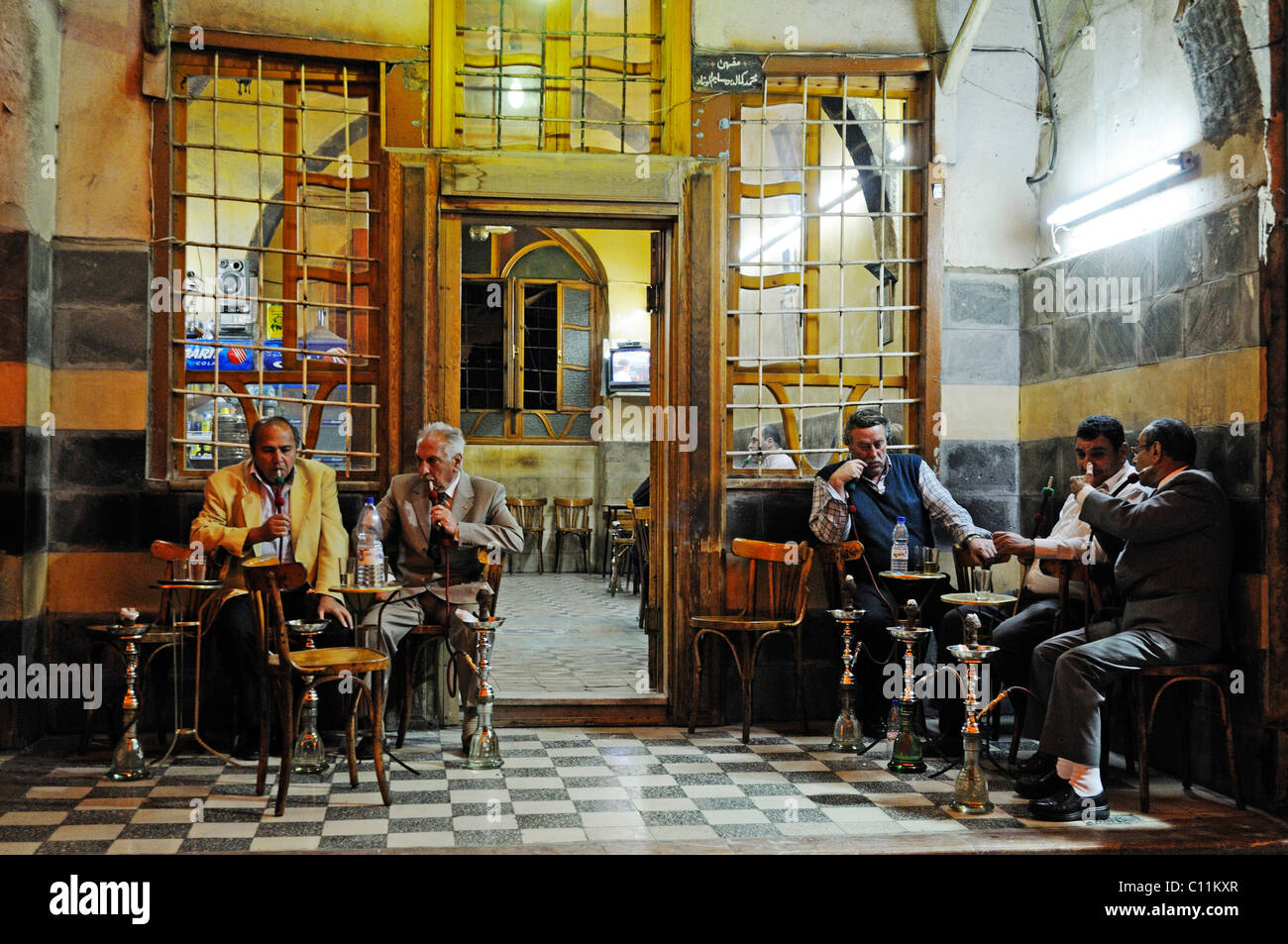 Men smoking a hookah in a cafe in the historic centre, bazaar of Damascus, Syria, Middle East, Asia Stock Photo