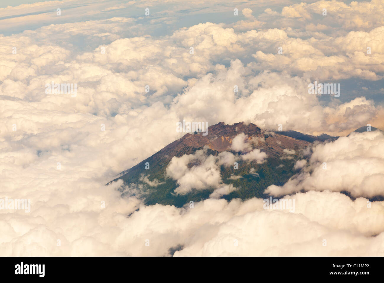 Aerial view through clouds of one of several volcanoes on Bali island, Indonesia Stock Photo