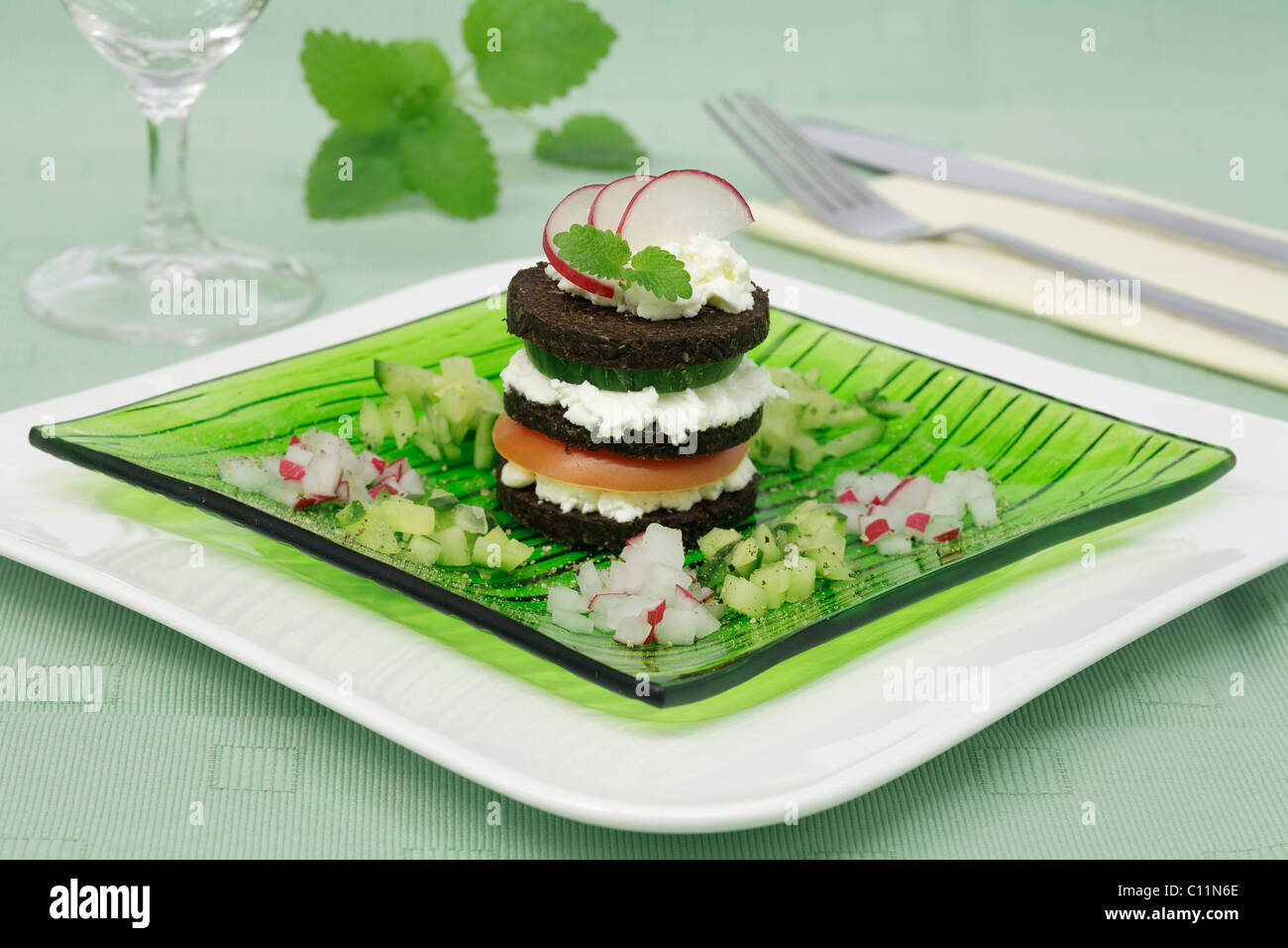 Pumpernickel with cream cheese, tomato, cucumber and radishes Stock