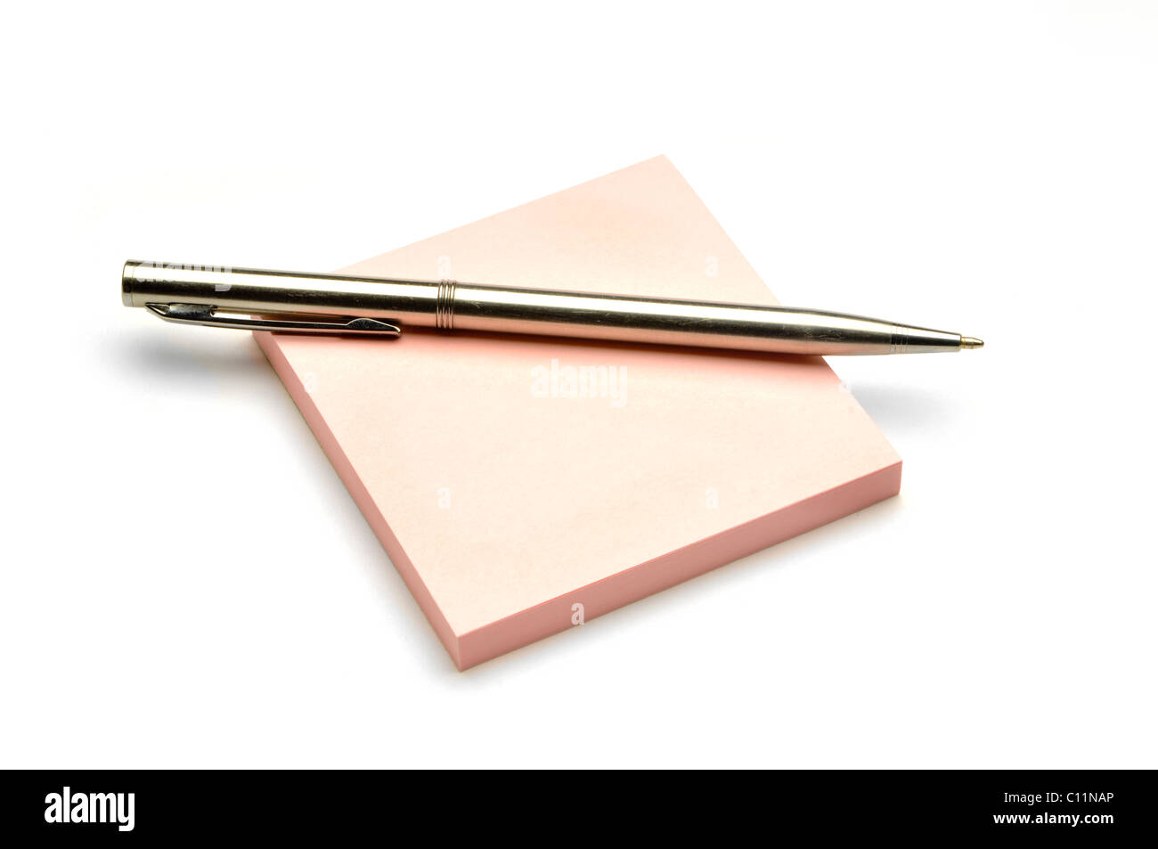 silver writing pen on colored note pad Stock Photo
