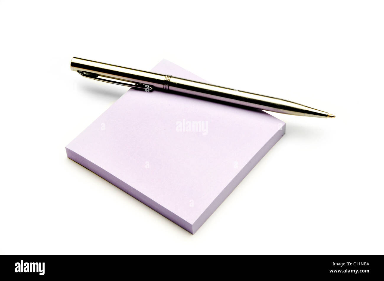 silver writing pen on colored note pad Stock Photo