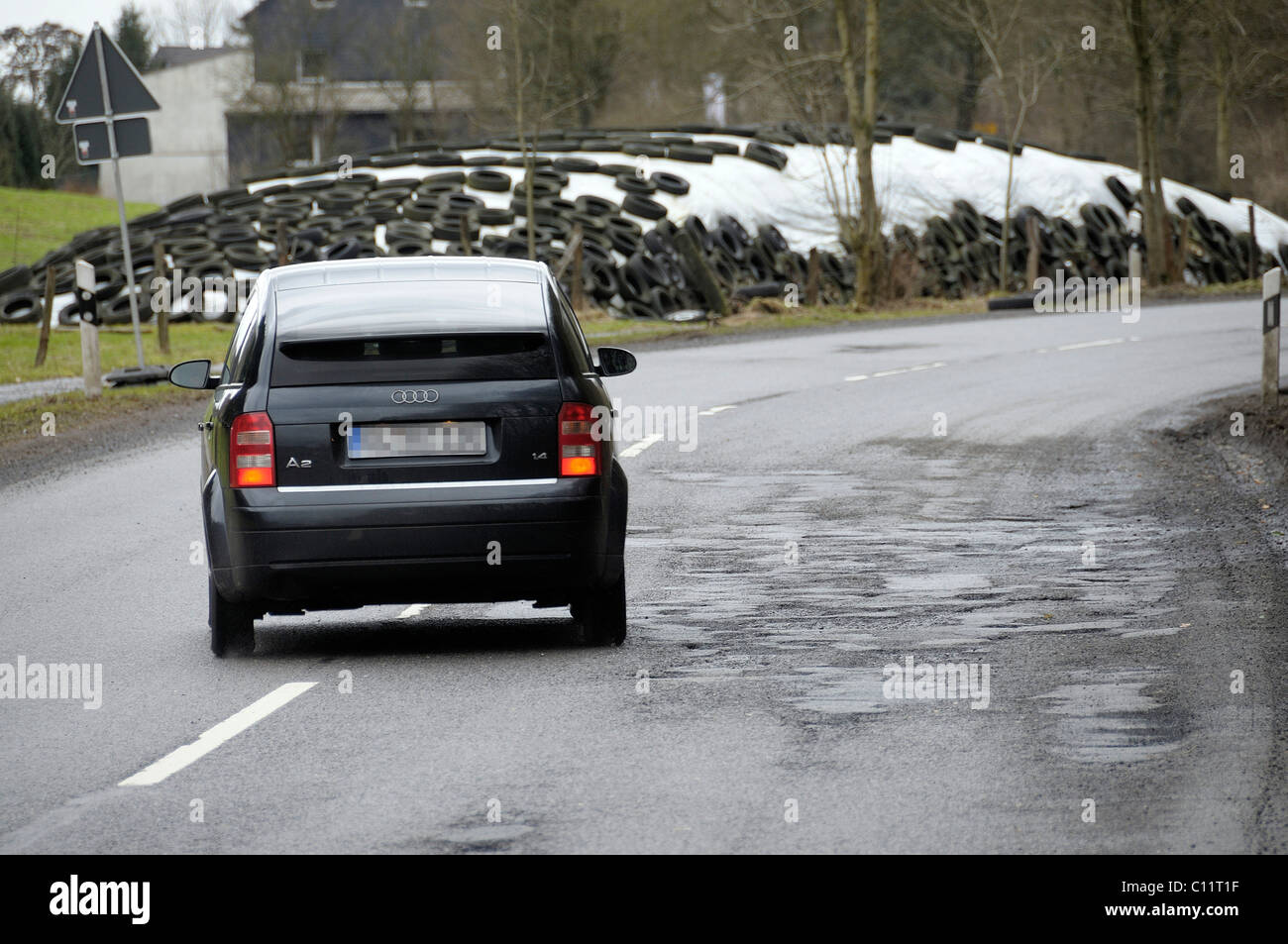 Car avoiding potholes, road damage on the L286, North Rhine-Westphalia, Germany, Europe Stock Photo