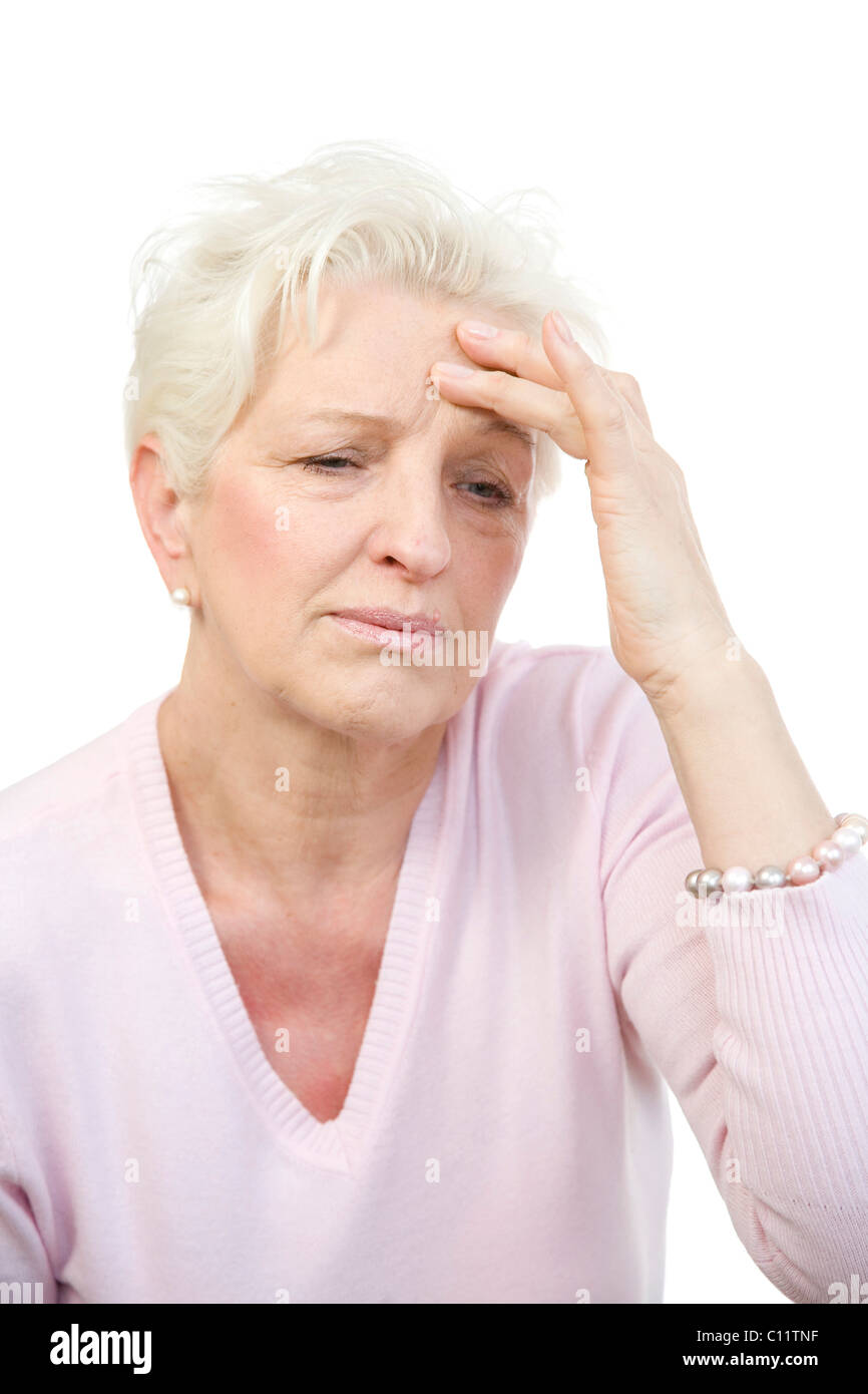 Old woman putting hand to her temple, face twisted with pain Stock ...