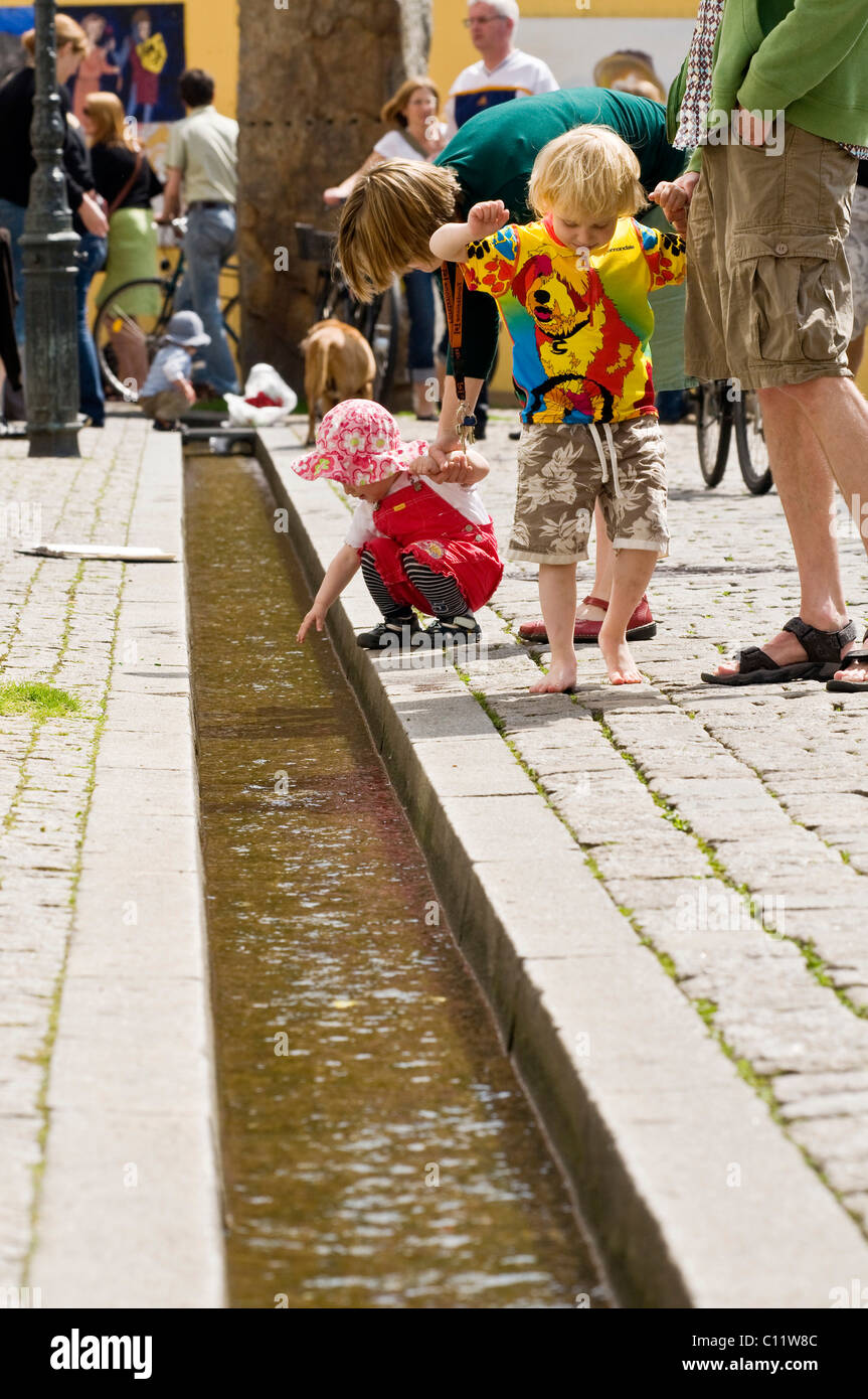 Children and Freiburger Baechle brook, Freiburg, Baden-Wuerttemberg, Germany, Europe Stock Photo
