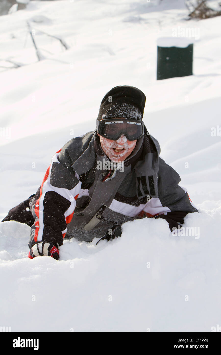 Skier, without a helmet, after a fall Stock Photo Alamy
