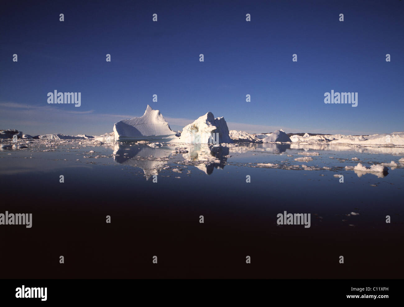 Icebergs with reflection in the Kangia Ice Fjord, Ilulissat, Jabobshavn, Greenland Stock Photo
