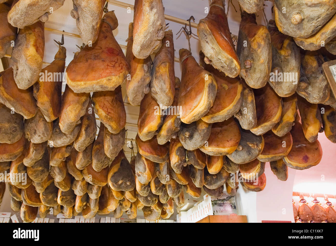 Ham hanging from the ceiling in the delicatessen shop, Norcineria Falorni, Greve, Chianti, Tuscany, Italy, Europe Stock Photo