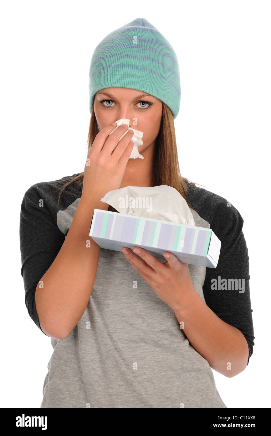 Portrait of young woman blowing her nose isolated over white background Stock Photo