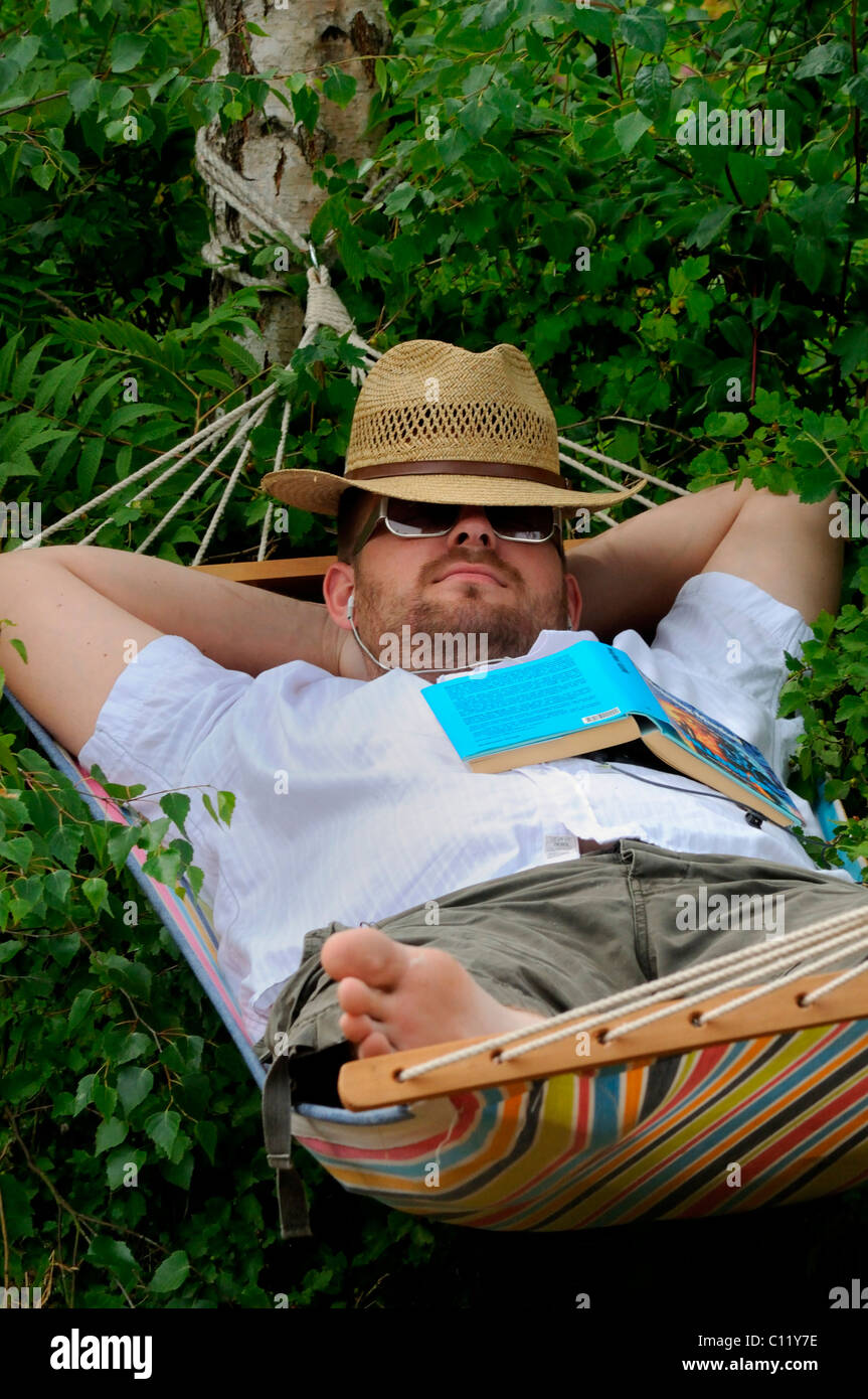 Man sleeping in a hammock Stock Photo