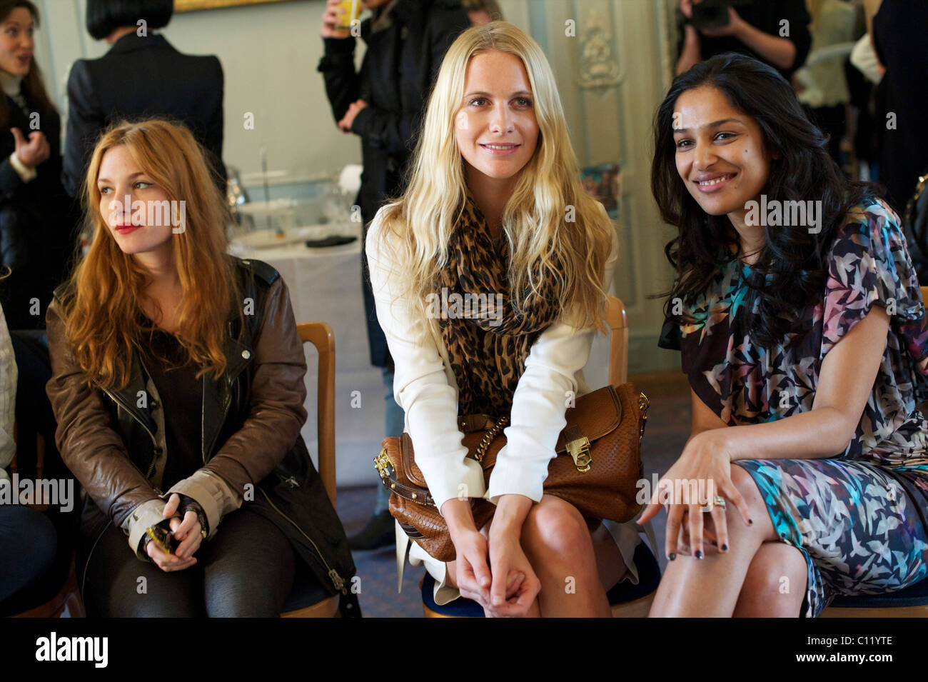 Josephine de la Baume and Poppy Delevigne sit next to Saloni Lodha (L-R) during the Saloni autumn 2011 collection at the Savile Stock Photo