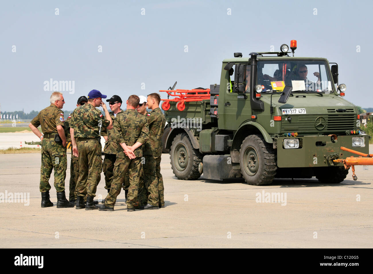 Group of Polish soldiers at a meeting, Unimog of the German Army, ILA 2008, International Aerospace Exhibition, Berlin Stock Photo