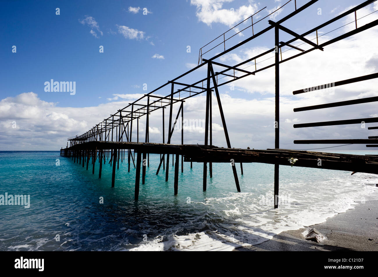 Old loading bridge, turquoise sea caused by pumice sediments on the seabed on Lipari, Isola Eolie, Sicily, Italy, Europe Stock Photo