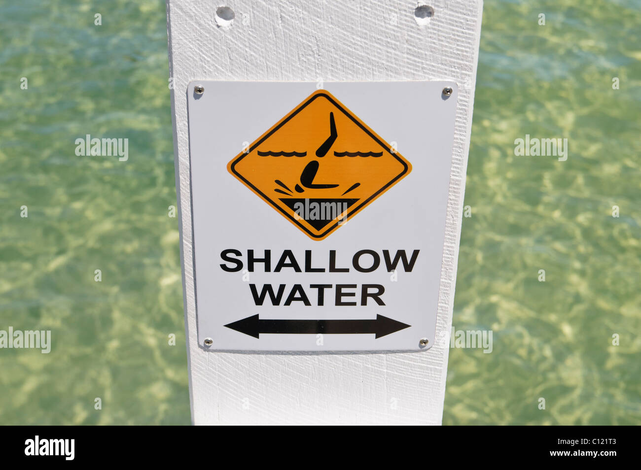 Selective focus on shallow water sign indicating that it is dangerous to dive in, Busselton, Western Australia Stock Photo