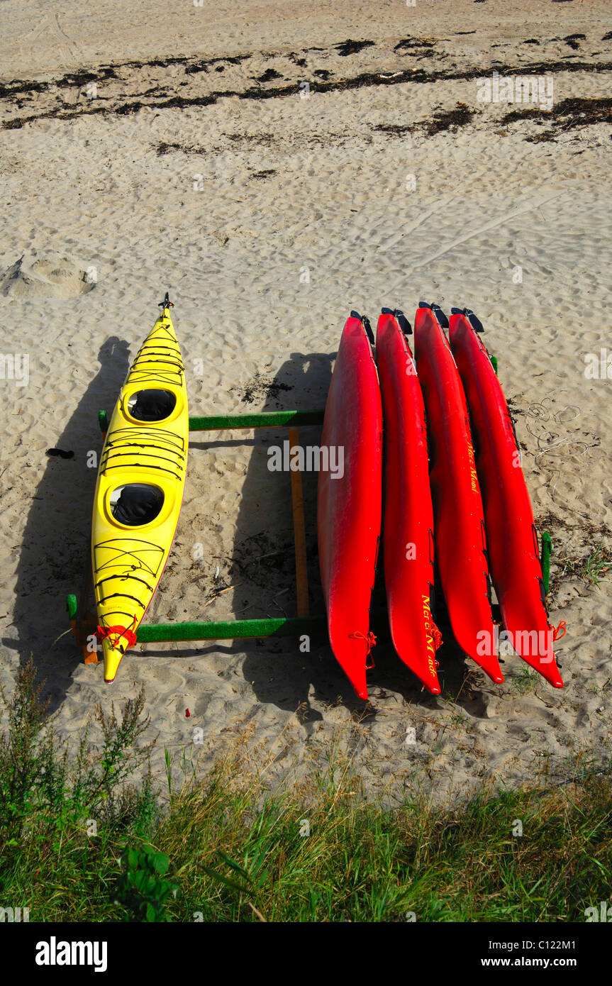 Yellow and red kayaks on a beach, Tadoussac, Canada Stock Photo