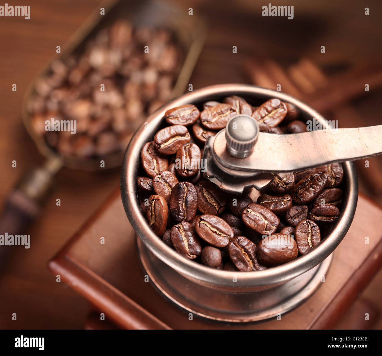 Roasted coffee beans are ground in a coffee grinder Stock Photo - Alamy