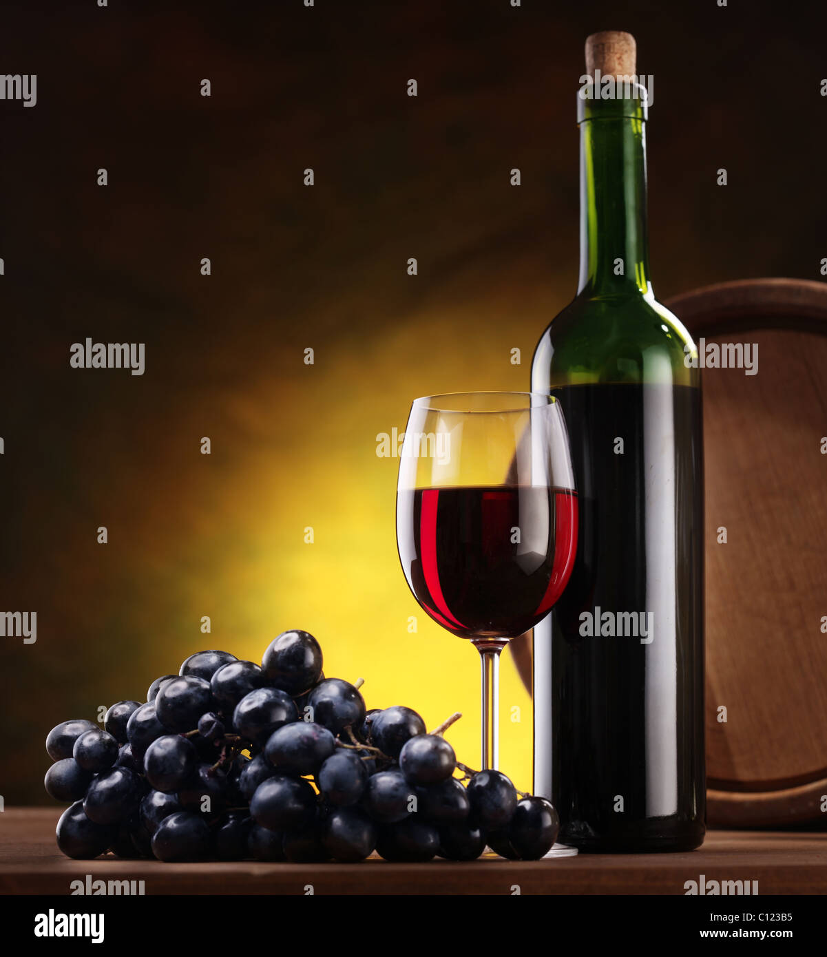 Still life with wine bottle, glass and oak barrels Stock Photo - Alamy