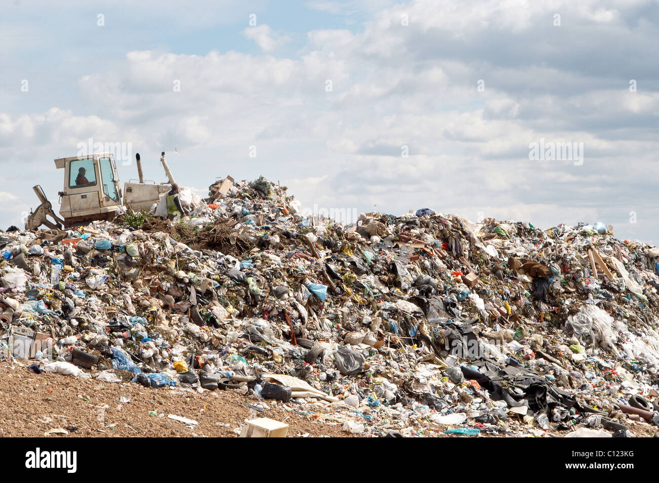 Bulldozer working on mountain of garbage in landfill Stock Photo Alamy