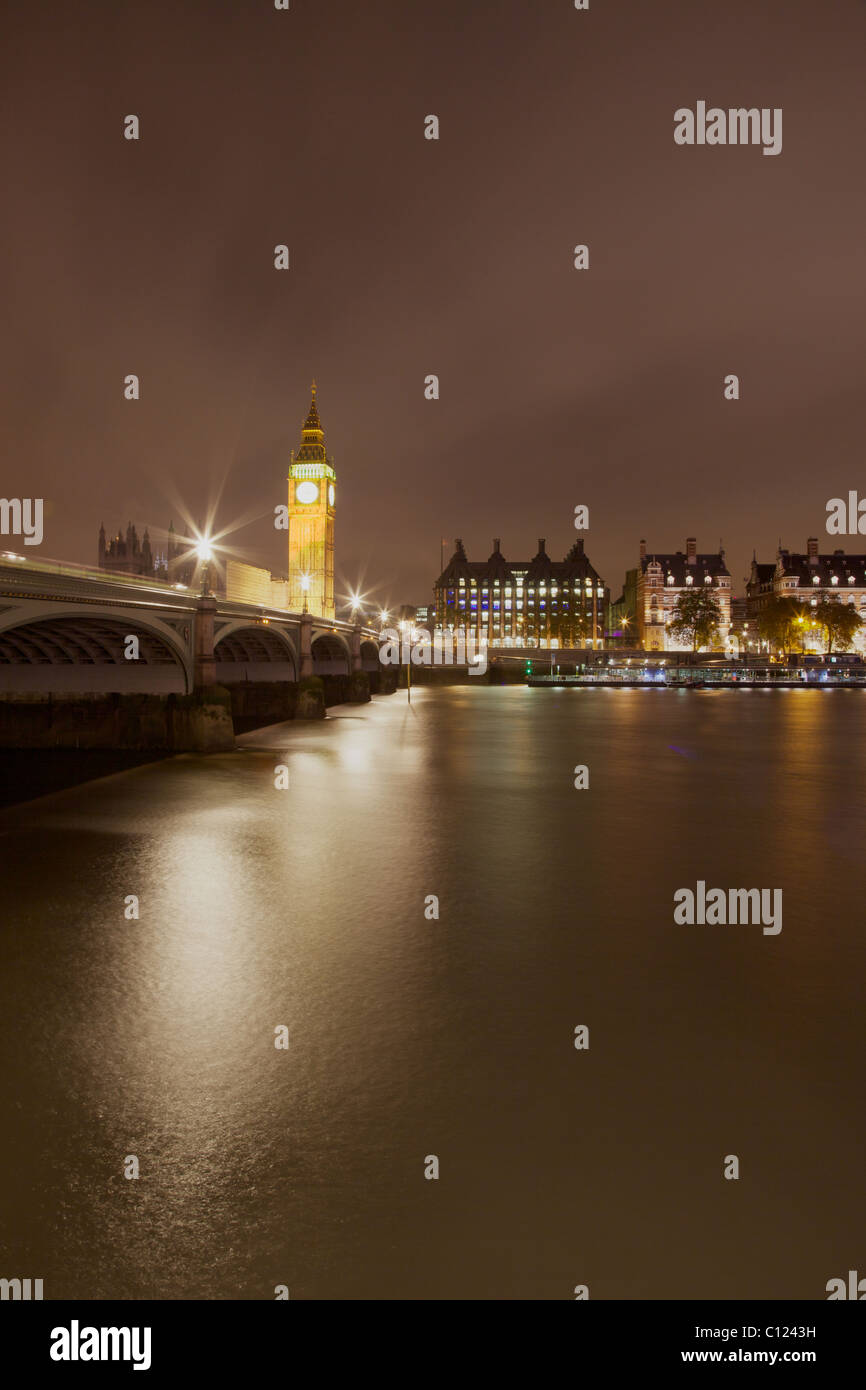 A dramatic night view of Westminster Bridge and 'Big Ben' in London. Portcullis House can also be seen on Victoria Embankment. Stock Photo
