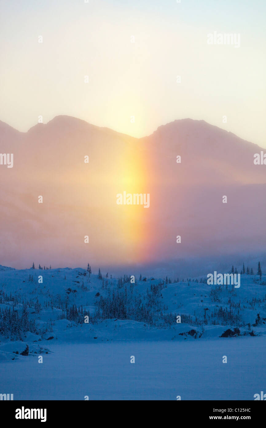 Drifting ice crystals form sun dog, sundog, parhelion, halo, White Pass, connecting Skagway, Alaska with British Columbia Stock Photo