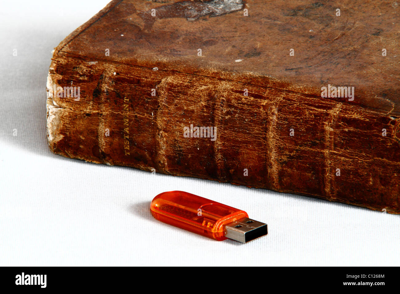 Old book with leather cover and inscription TESTAMENT and USB stick Stock Photo