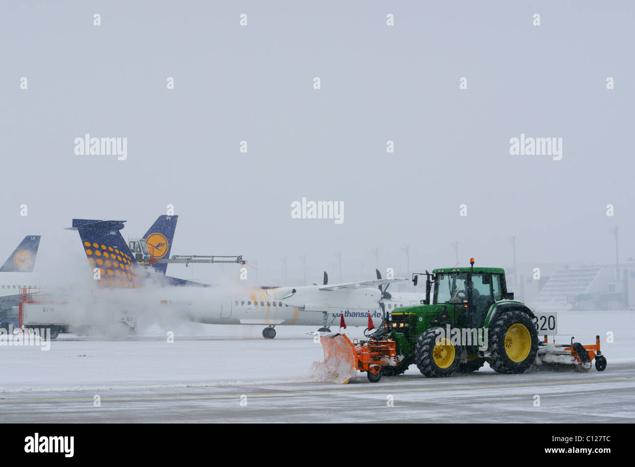 Snow, winter, snow removal with tractors, aircraft, taxiway, Terminal 2, east apron, Munich Airport, MUC, Bavaria Stock Photo