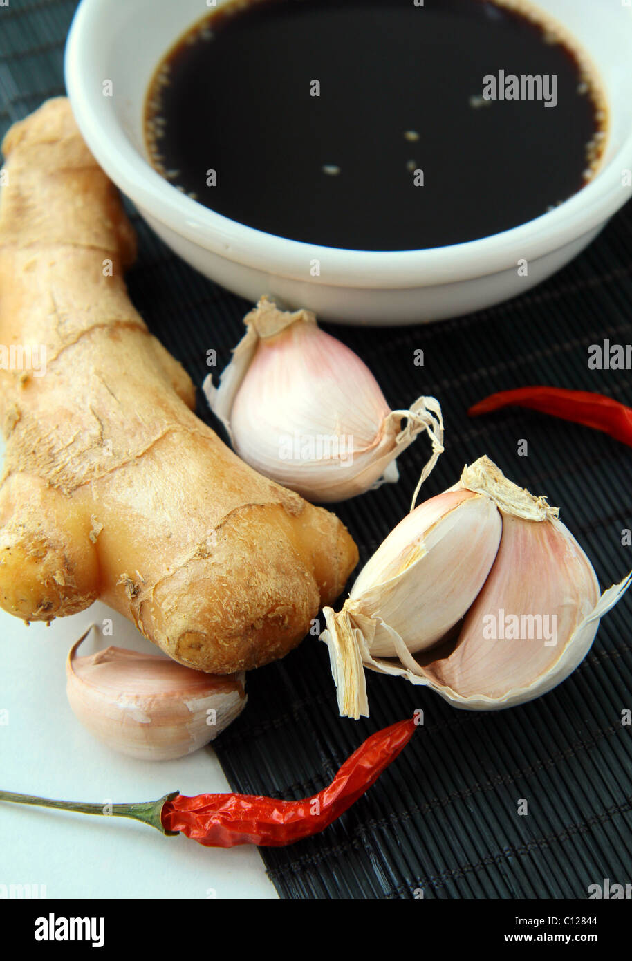 traditional asian ingredients  uncooked rice, ginger, garlic, soy sause Stock Photo