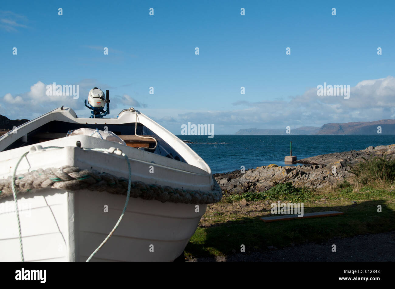 A white boat on the coast of Easdale - Scotland. Stock Photo
