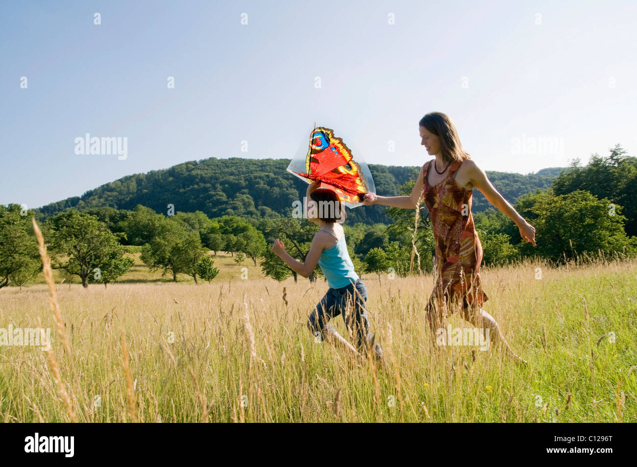 Mother and child with a kite in a summer meadow in the Black Forest, Baden-Wuerttemberg, Germany, Europe Stock Photo