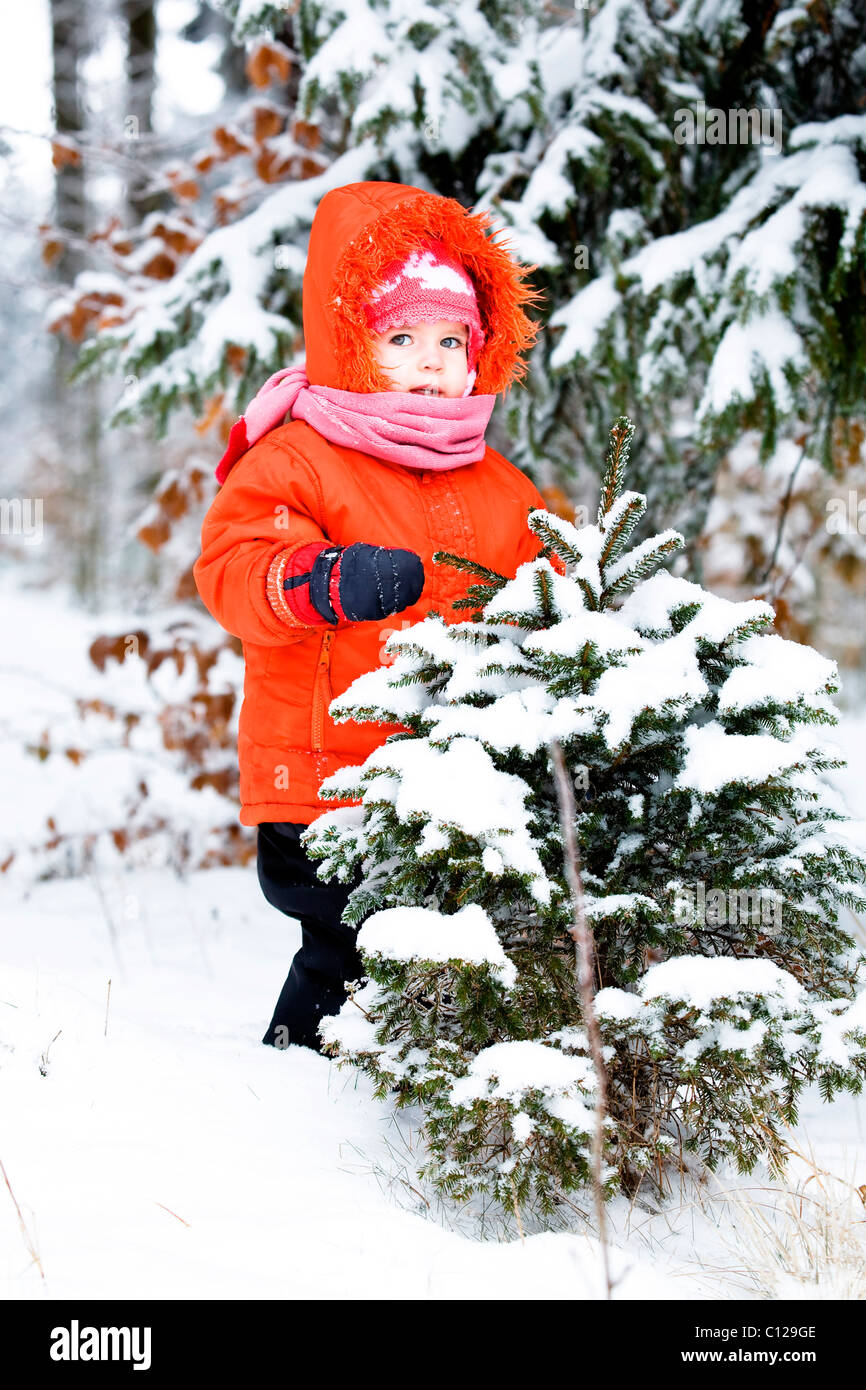 Little girl in a snowy forest Stock Photo - Alamy